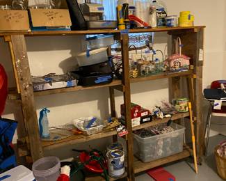 Shelf unit with Christmas tree stands, bake pan, lights.