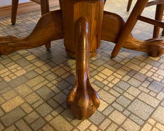 Claw foot round table opens to oblong with six chairs.