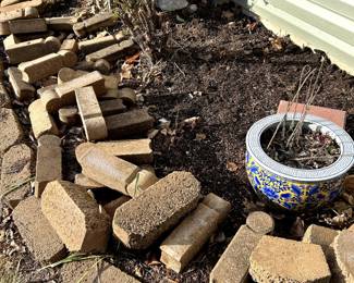 Lots of landscaping bricks and misc rocks, ceramic pot