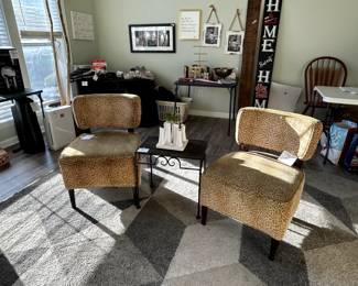 pair of leopard print slipper chairs, large rug. two porch signs and misc wall art