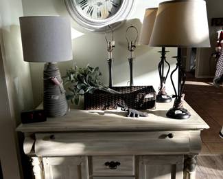 Very cute, cabinet/sideboard, with drawers and doors, it is on wheels , so cute. Large clock and three pair of lamps, vintage boot jack and long narrow basket