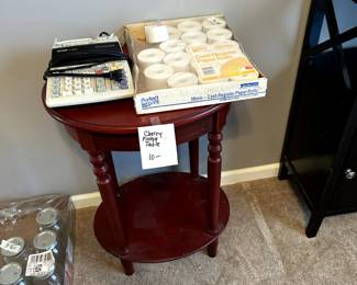 small table, calculator with rolls of tape, box of jars on floor