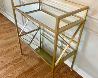 Gold metal bar cart with mirrored shelves