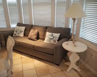 Neutral sleeper sofa; accent table - two available; table lamp - two available