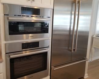 Jenn-Air refrigerator with Obsidian interior; counter depth; multi-point cinematic lighting; capacitive touch controls with LED display; glass shelving. BOSCH microwave & wall oven mfg. 9/2024