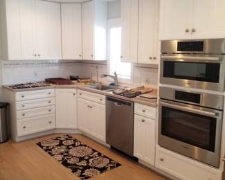 Clean white kitchen cabinetry; BOSCH microwave & wall oven mfg. September 2024