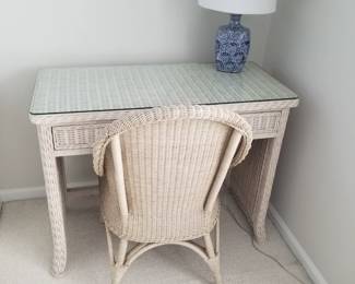 Wicker writing desk with matching chair; table lamp