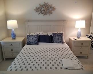 Queen bedroom suite: queen bed; end tables; tall dresser; metal wall art