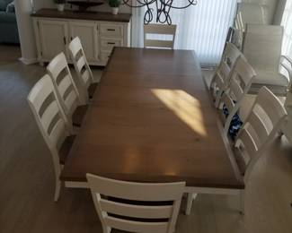 Dining table seats 8; shown fully extended. Has two leaves.