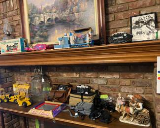 Lots of vintage toys. Toy locomotive, toy battery sewing machine, rare pink kit cat clock. Vintage tonka fork lift and scraper. Etch A Sketch in box, Tom Thumb Cash Register with Box. Several vintage 35mm cameras. 2 vintage Sears Binoculars. Signed sports Memorabilia. 
