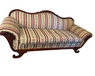 Vintage Victorian Style Sofa With Ornate Carved Wood And Striped Upholstery