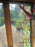 Stain glass window inserts, forms an archway around the window or door.
