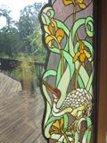 Stain glass window inserts, forms an archway around the window or door.