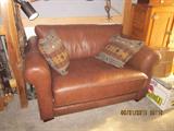 Leather Loveseat, converts to twin bed.