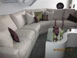 Curved sectional sofa, custom made coffee table, household decorations. Next picture shows custom made tables for back edges of sofa.