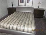 Queen size bed, nightstands, bedding.