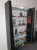 Marble and glass shelving unit, golf trophies.