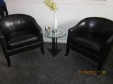 Black leather club chairs, side table