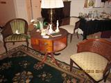 Round leather top drum table, book shelves and drawers.