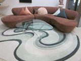 Contemporary Sofa, rug is sculpted to fit and around and flow with sofa. Glass top coffee table