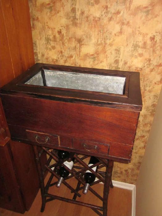 Antique/Vintage cooler. Sitting on a wine rack