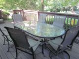 Patio table with umbrella and 6 chairs.