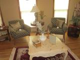 Coffee table, rug, matching chairs, miscellaneous tables, lamps.