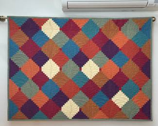 Colorful Quilted Wall Hanging | On a brass hanging rod, featuring a repeating pattern, finished with a bound edge
Dimensions: h. 33.25 x w. 47 in
