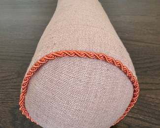 Pair of Oatmeal Cotton / Linen Bolsters with Orange Cord Trim. Photo 1 of 2.