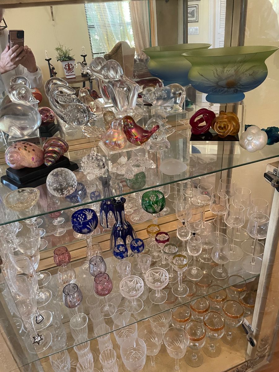 A sample of one cabinet full of beautiful crystal items from Bohemian glass to a leak and other side pieces, including Fenton