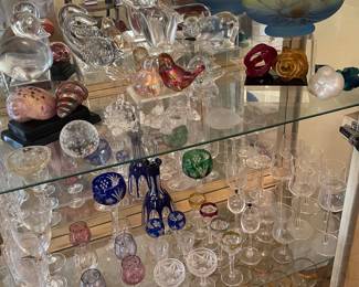 A sample of one cabinet full of beautiful crystal items from Bohemian glass to a leak and other side pieces, including Fenton
