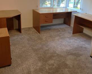 In the same room is the four-piece office furniture: desk, corner desk, side table (credenza?), and the two-drawer filing cabinet.