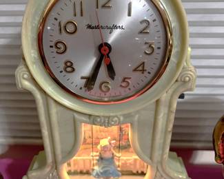 This clock, by Mastercrafters, is quite interesting. You'll have to come by the sale to see if the girl swings as part of the alarm.