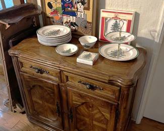 There is a small Christmas dish set as can be seen on the side cabinet. One of the dining table leaves is shown on the far left.