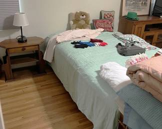 This is a better look at the twin bed, along with a few pillows and a nightstand.