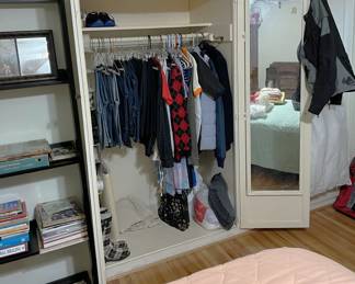 This sale does have a little bit of clothing in it. Here is one of the closets. You can also see a portion of the bed, and a few items on the bookcase.