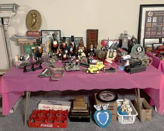 To the left, there are a number of crow statues, and below the table in a white box the Pillsbury Dough Boy family of toys. If you are in the need of a standing scale (like from the doctor's office), we have one of those.