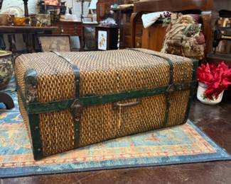 antique wicker trunk with metal edging and straps lined with rice paper