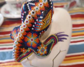 Huichol beadwork - Iguana climbing out of a shell.  Signed.