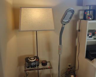 Glass topped table with 2 shelves and attached lamp.  Verilux task lamp with flexible neck..