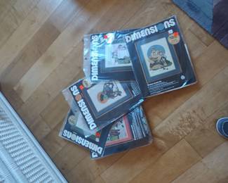 Unopened counted cross stitch kits from Dimensions.  All are inspired by Norman Rockwell paintings.