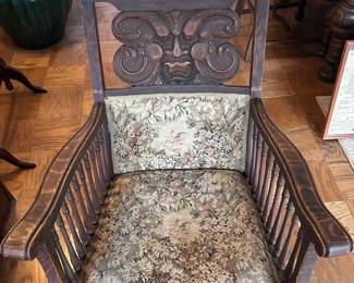Antique wooden rocking chair with carved back detail