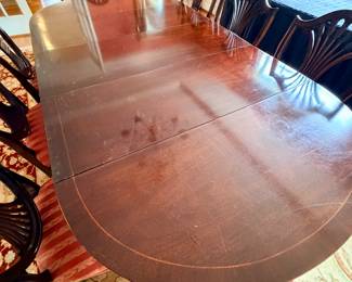 Banded mahogany dining table with 3 leaves (shown).