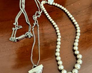 Vintage Givenchy  "shark tooth" pendant (left) and Tiffany & Co. sterling silver graduated bead necklace (right)
