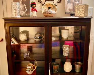 Glass front display cabinet, you will find decorative tin mirrors and other South West style decorative accents 