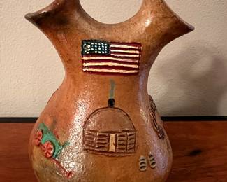 Navajo pot featuring a hogan and American flag 