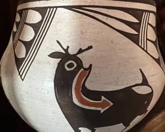 Acoma Pueblo pot featuring a deer with a heart line signed Rose Chino