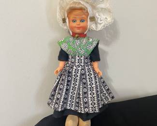 vintage Dutch girl doll in traditional costume, featuring a lace hat and wooden clogs. from South Beveland (Zuid-Beveland). The shape of the woman’s hat shows that they are Roman Catholics.