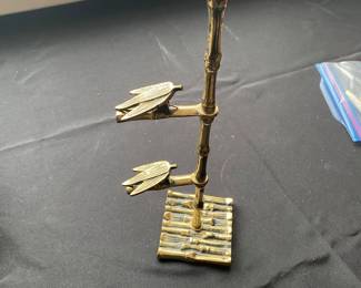 a vintage brass bamboo memo or card holder.
It features a Victorian style design with a bamboo motif. The item has three tiered clips for holding notes, business cards, or photos.