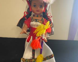 vintage Huichol doll, these dolls are known for their vibrant, handmade clothing and intricate details.
